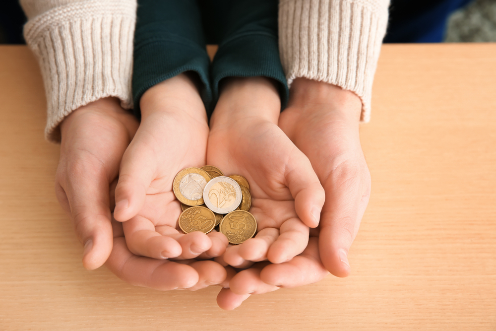 Hands,Of,Young,Man,And,His,Son,Holding,Coins,On